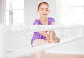 Positive spaces makes for better learning. a little girl practicing ballet in a dance studio.