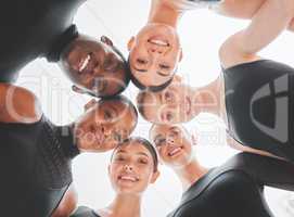 Hold on to your seats because were going to blow you away. a group of ballet dancers standing together in a huddle.
