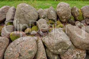 Closeup of a stone wall made of boulders and rocks outside. Background of rustic, rural building and masonry material. Historic housing design or antique architecture of an urban structure outdoors