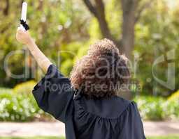 The best is yet to come. Rearview shot of a young woman cheering on graduation day.
