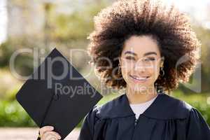 Im going to make the most of my achievement. Portrait of a young woman holding her cap on graduation day.