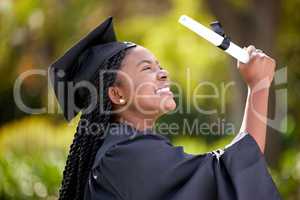 Mastered it and have the paper to prove it. a young woman cheering on graduation day.