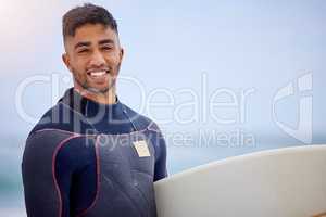 Once a surfer, always a surfer. Portrait of a handsome young man carrying a surfboard at the beach.