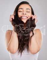 The best hairstyle is the one that looks good on you. Studio shot of a young woman with beautiful long hair.