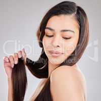 You should make an appointment with my hairstylist. Studio shot of a young woman with beautiful long hair.