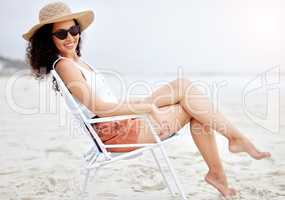 This is my idea of me time. a young woman enjoying a day at the beach.