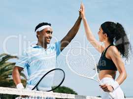 We gave it our all. tennis teammates sharing a high five during a tennis match.