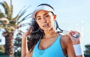 Im destined to be the next champion. an attractive young woman standing and holding a tennis racket while looking contemplative during practice.