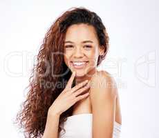 Covered in giggles. Portrait of a beautiful young woman showing off her natural curly hair against a white background.