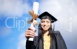Its one of many more great rewards to come. Closeup shot of a young woman holding her diploma on graduation day.