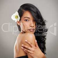 You are capable of amazing things. a beautiful young woman posing with a flower in her hair.