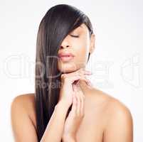 My hair is soft, manageable and just plain lovely. a young woman posing against a white background with healthy looking hair.