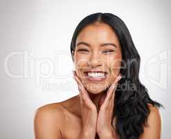 Look at how gorgeous my skin looks. a beautiful young woman posing against a grey background.