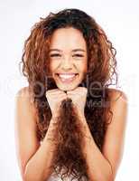 Strength Ive earned. Portrait of a beautiful young woman showing off her natural curly hair against a white background.