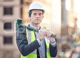 Im here to do a complete rebuild. Cropped portrait of a handsome male construction worker standing with a hammer on a building site.