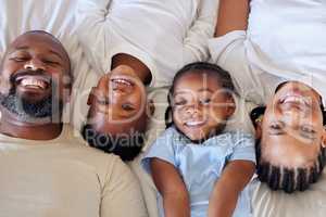 Happy african american family relaxing together and bonding at home. Little brother and sister spending time with their parents. Parents showing off their smiles and white teeth with their children