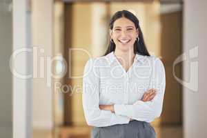 Scoring success is a simple task for her. Portrait of a confident young businesswoman standing with her arms crossed in an office.