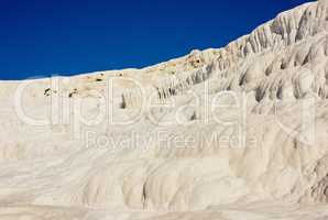 Scenic view of travertine pools and terraces in Pamukkale, Turkey. Traveling abroad, overseas for vacation and tourism. Cotton castle area with a carbonated mineral after flowing thermal spring water