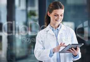 Getting some of her admin done between rotations. a young female doctor using a digital tablet in a hospital.