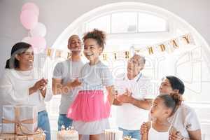 A birth-date is a reminder to celebrate life. a little girl enjoying a birthday party with her family at home.