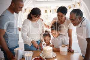 The secret of staying young is to live honestly. a family cutting a cake and celebrating a birthday party at home.