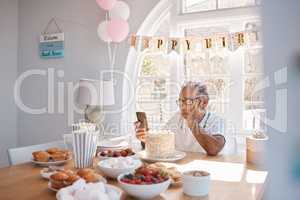 The most terrible poverty is loneliness. a senior man looking unhappy while celebrating his birthday alone at home.