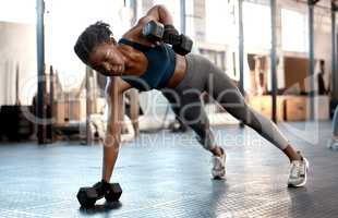 You will succeed, not immediately but definitely. a sporty young woman exercising with dumbbells in a gym.