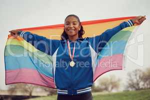 Everybody deserves to love. a female athlete holding a pride flag.