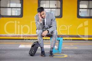 I have zero motivation for work today. a young businessman looking stressed out while sitting on a bench at a railway station during his commute.