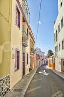 Historical city street view of residential houses in small and narrow alley or road in tropical Santa Cruz, La Palma, Spain. Village view of vibrant buildings in popular tourism destinations overseas