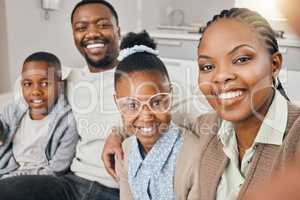 Say cheese. a young family taking a selfie together at home.