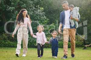 Time is non-refundable - use it with intention. Shot of a happy family bonding together outdoors.