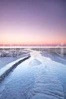 Landscape view of a sunset in a pink sky on the beach and West Coast of Jutland, Denmark. A beautiful sunrise on the calm seashore for a getaway vacation and tourism. Peaceful scenery at the ocean