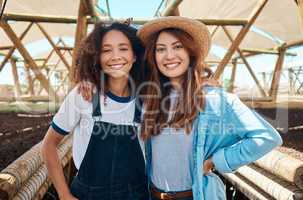 Making crop farming more sustainable, profitable and effortless. Portrait of two young women working on a farm.