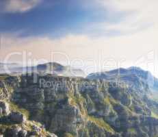 Copy space with scenic landscape of clouds in the sky covering the peak of Table Mountain in Cape Town on a misty morning. Amazing views from high above a rocky valley after a summit up a mountain