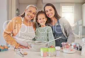 When you crave something sweet, well whisk it up. Shot of a little girl baking with her mother and grandmother at home.