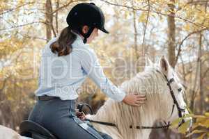 When I bestride him, I soar. an young woman riding with her horse outside.