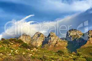 Landscape view of mountains and blue sky in Cape Town, South Africa during summer holiday and vacation. Scenic hills of fresh green flora growing in remote area. Exploring mother nature and the wild