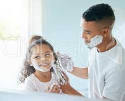 Nothing is more precious than a fathers love. a little girl and her father playing around with shaving cream in a bathroom at home.