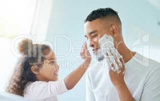 Let me help you with that. a little girl and her father playing around with shaving cream in a bathroom at home.