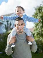 Family is everything to me. a young man carrying his daughter on his shoulders.