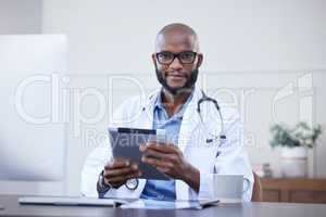Now I can keep track of my schedule easily. a young male doctor using a digital tablet in an office at a hospital.