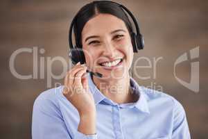 Face of businesswoman working in a call center. Customer service operator wearing a headset. Portrait of happy service rep. IT customer service rep. Smiling customer service agent on a call