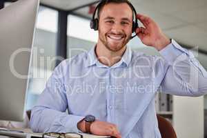 Nothing better than making you smile. a young businessman working in a call center.