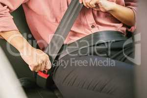 Buckle up, its for your own good. a unrecognizable woman fastening her seatbelt in a car.