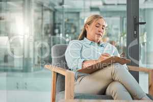 She knows how to identify the signs. a mature psychologist sitting in her practice and writing on a clipboard.