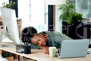 Power naps are helpful for productivity. a young businesswoman taking a nap at work.