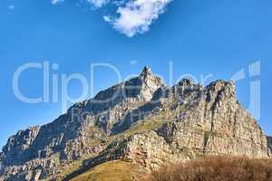 Beautiful landscape of Table Mountain below with blue sky and copy space. Peaceful and scenic view of a peak with large rocks and grass. A summit in nature ideal for adventure walks and hiking trips