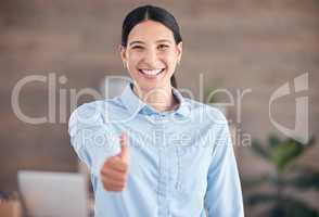 Smiling mixed race businesswoman standing alone and using hand gestures to make a thumbs up. Confident and ambitious hispanic professional wishing good luck symbol and sign. Endorsing and approving