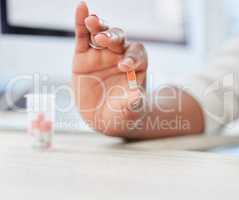 Keeping both the body and mind strong. a businesswoman holding a capsule.